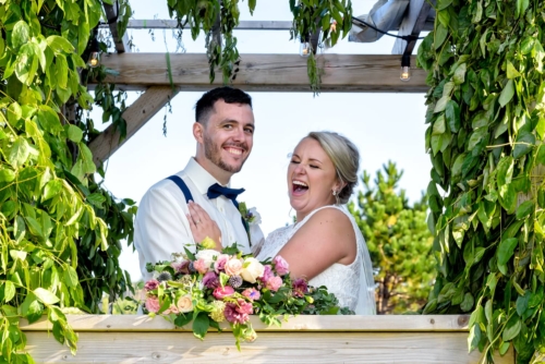 The bride and groom pose for wedding photos during their wedding at the barn at Sadie Belle Farm.