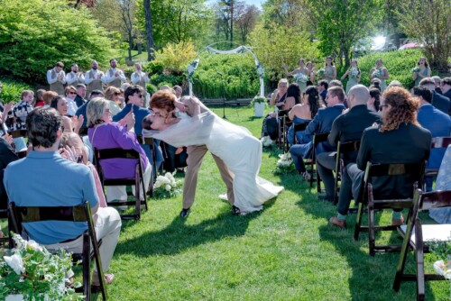 The groom dips his bride on the walk back down the aisle after their wedding ceremony at the Ashburn Golf Course in Halifax NS.